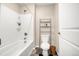 A full bathroom featuring a shower-tub combo and tiled floor at 91 S Quantock St, Aurora, CO 80018