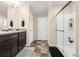 Bathroom features a dual sink vanity, and a glass-enclosed shower at 91 S Quantock St, Aurora, CO 80018