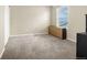A simple carpeted bedroom with a neutral color scheme and plenty of natural light at 91 S Quantock St, Aurora, CO 80018