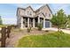 Charming two-story home with a well-manicured lawn and a blue garage door at 91 S Quantock St, Aurora, CO 80018
