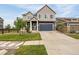 Charming two-story home with a well-manicured lawn and a blue garage door at 91 S Quantock St, Aurora, CO 80018