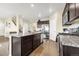 Modern kitchen featuring granite countertops, stainless steel appliances, and a large center island at 91 S Quantock St, Aurora, CO 80018