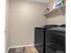 Dedicated laundry room with modern washer and dryer and ample shelf storage at 91 S Quantock St, Aurora, CO 80018