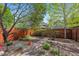 Back yard featuring garden plots, stone walkway, and privacy fence at 2502 Alton St, Denver, CO 80238