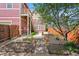 Back yard featuring garden beds, stone paths, and a privacy fence at 2502 Alton St, Denver, CO 80238