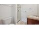 The bathroom features a framed glass shower, vanity, faucet, tile accents and a comfort height toilet at 2502 Alton St, Denver, CO 80238