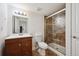 Bathroom featuring a vanity, toilet, and glass shower with tile surround at 2502 Alton St, Denver, CO 80238