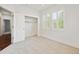 The bedroom includes shuttered windows, carpeting and a walk-in closet for ample storage at 2502 Alton St, Denver, CO 80238