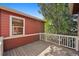 Outdoor deck overlooking a private backyard setting with mature trees and natural light at 2502 Alton St, Denver, CO 80238