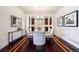 Elegant dining room with modern chandelier, hardwood floors, and stylish decor at 2502 Alton St, Denver, CO 80238
