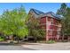 Home exterior featuring solar panels, well-maintained yard, and mature trees at 2502 Alton St, Denver, CO 80238