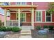 Inviting covered front porch with seating area and decorative details at 2502 Alton St, Denver, CO 80238