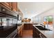 Gourmet kitchen featuring modern appliances, sleek countertops, and seamless flow to the living area at 2502 Alton St, Denver, CO 80238