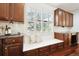 Bright kitchen nook featuring a window seat, storage cabinets, and hardwood flooring at 2502 Alton St, Denver, CO 80238