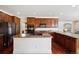 Open kitchen with a central island, double ovens, and rich wood flooring at 2502 Alton St, Denver, CO 80238