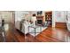 Living room with hardwood floors, fireplace, built-in bookshelves, and open layout at 2502 Alton St, Denver, CO 80238