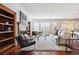 Bright living room features fireplace, built-in shelving and lots of natural light at 2502 Alton St, Denver, CO 80238