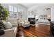 Open-concept living room with fireplace, hardwood floors, lots of natural light, and neutral decor at 2502 Alton St, Denver, CO 80238