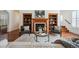 Comfortable living room with fireplace, built-in shelves and soft white rug at 2502 Alton St, Denver, CO 80238