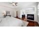 Sun-filled main bedroom with hardwood floors, fireplace, recessed ceiling and ensuite bathroom access at 2502 Alton St, Denver, CO 80238