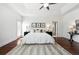 Bright main bedroom boasts tray ceilings, ceiling fan, hardwood floors and an ensuite bathroom at 2502 Alton St, Denver, CO 80238