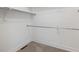 A walk-in closet features carpet floors, base trim and dual rods for hanging and storing your wardrobe at 2502 Alton St, Denver, CO 80238