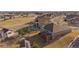 Aerial shot displays a beautiful backyard with a deck and yard, and shows the neighborhood and a pond in the distance at 22725 E Long Dr, Aurora, CO 80016