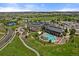 Aerial of community clubhouse with pool, golf course, and surrounding residential area at 22725 E Long Dr, Aurora, CO 80016