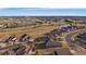 A high aerial view showcases homes near golf course and ponds on a bright day at 22725 E Long Dr, Aurora, CO 80016