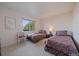 Bright bedroom featuring two beds, a window with a view, and light walls, creating a cozy and inviting space at 22725 E Long Dr, Aurora, CO 80016