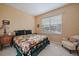 Cozy bedroom with a colorful quilt on the bed and a large window for natural light at 22725 E Long Dr, Aurora, CO 80016