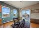 Cozy dining area with natural light from three windows and a sliding glass door to the deck at 22725 E Long Dr, Aurora, CO 80016