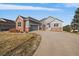 A beautiful house with a long driveway and well-manicured lawn and an attached garage at 22725 E Long Dr, Aurora, CO 80016