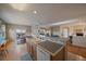 Open-concept kitchen flows into a dining area, and a living space with an entertainment center at 22725 E Long Dr, Aurora, CO 80016