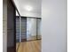 Walk-in closet with mirrored sliding doors and built-in shelving at 1625 Larimer St # 1001, Denver, CO 80202