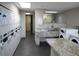 Well-lit laundry room with multiple washers and dryers, plus a marbled folding table and sink for convenience at 1625 Larimer St # 1001, Denver, CO 80202