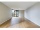 Bright living room featuring expansive windows offering city views and hardwood flooring at 1625 Larimer St # 1001, Denver, CO 80202