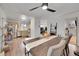 Dining room open to the kitchen and living room with a dark wood table and neutral walls at 16403 E Radcliff Pl # A, Aurora, CO 80015