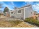 Charming home featuring gray siding, manicured landscaping and a well-maintained lawn at 16403 E Radcliff Pl # A, Aurora, CO 80015