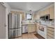 Bright kitchen featuring stainless steel appliances, white cabinets, and tile flooring at 16403 E Radcliff Pl # A, Aurora, CO 80015