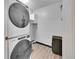 Laundry room features a stacked washer and dryer and cabinet storage at 16403 E Radcliff Pl # A, Aurora, CO 80015