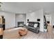 Cozy living room featuring a fireplace, leather sofa, hardwood flooring, and recessed lighting at 16403 E Radcliff Pl # A, Aurora, CO 80015