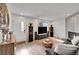 Inviting living room featuring hardwood floors, fireplace, and sunburst mirror at 16403 E Radcliff Pl # A, Aurora, CO 80015