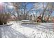 Snowy backyard with a trampoline and playground at 21792 Silver Meadow Ln, Parker, CO 80138