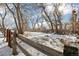 Wooded backyard with a split-rail fence at 21792 Silver Meadow Ln, Parker, CO 80138