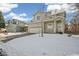 Two story house with a snow covered lawn at 21792 Silver Meadow Ln, Parker, CO 80138