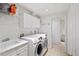 Laundry room with washer, dryer, and storage cabinets at 21792 Silver Meadow Ln, Parker, CO 80138