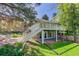 Walk-out basement with a beautiful backyard featuring a well-maintained lawn and a charming stone landscape design at 3561 Kalispell St, Aurora, CO 80011