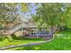 Backyard features a walk-out basement, lush green lawn, a patio area, and mature trees, perfect for outdoor entertaining at 3561 Kalispell St, Aurora, CO 80011