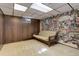 Finished basement with a couch, carpet flooring, drop ceiling and unique wall decorations at 3561 Kalispell St, Aurora, CO 80011